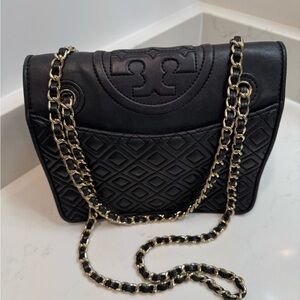 Tory Burch black leather handbag with gold type trim. Shoulder or crossbody bag.